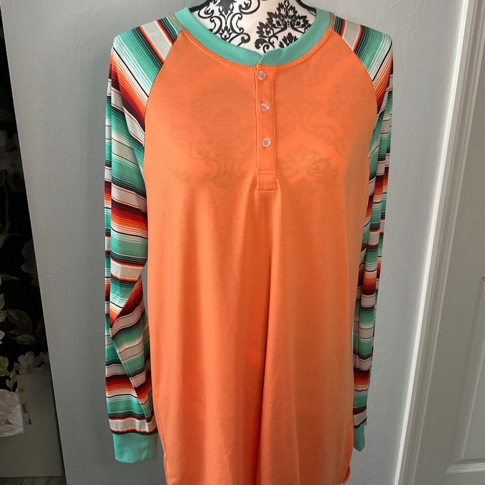 Orange shirt with teal striped sleeves